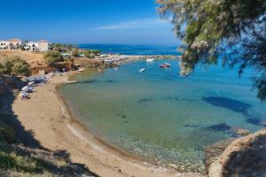 a beach with a group of boats in the water at Panormo Beach Hotel in Panormos Rethymno