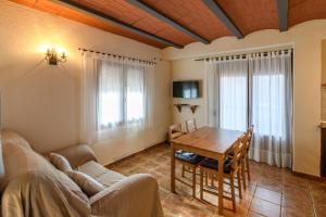 a living room with a table and a couch at Casa El Mirador in Beceite