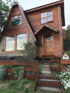 a log cabin with a front door and windows at Caba&ntilde;a Ahnen in Ushuaia