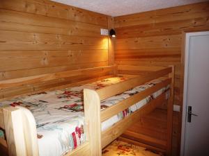 a wooden cabin with two bunk beds in it at Residence Sylvana in Les Deux Alpes