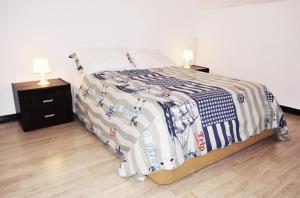 a bedroom with a bed with a blanket and two lamps at Bairro Alto Central Apartment Lisbon in Lisbon