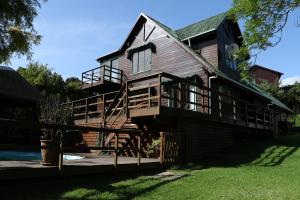 a large wooden house with a porch and a deck at Allan Grove in Knysna