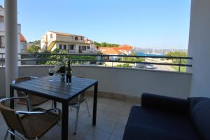 a table with two glasses of wine on a balcony at Nautica Apartments in Betina