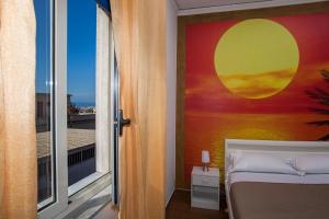 a bedroom with a bed and a window with a view at Enjoy Vida in Casola di Napoli