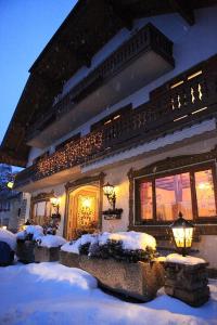 a house with snow on the ground in front of it at Gasthof Karlwirt in Sankt Andrä im Lungau