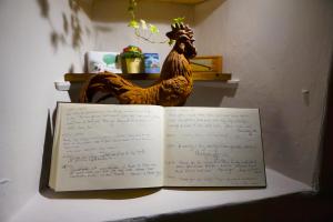 a book with a chicken sitting on top of it at The Game Cock Inn in Austwick