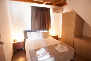 a small room with a bed with a window at Elounda Sunrise Apartments in Elounda