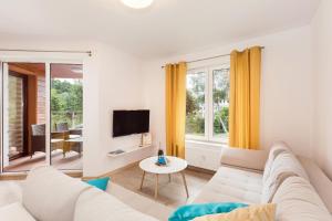 Televízia a/alebo spoločenská miestnosť v ubytovaní Grace Apartment I