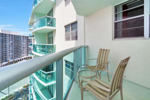 a balcony with two chairs and a table at 14#Stunning Beach Apt - Miami Te Espera- HOLLYWOOD in Hollywood