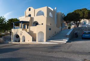 a building with stairs in front of a parking lot at Cultural House in Pyrgos