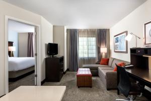 a hotel room with a couch and a bed at Staybridge Suites Chantilly Dulles Airport by IHG in Chantilly +38 photos