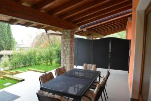 a patio with a table and chairs on a patio at Residence Boschetti in Manerba del Garda
