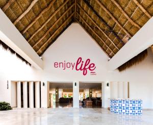 an entrance to an enjoy life sign on a building at Allegro Cozumel All-Inclusive in Cozumel