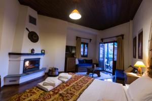 a bedroom with a bed and a fireplace at Hotel Ligeri in Elati