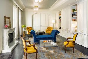 a living room with a blue couch and chairs at The Adelphi Hotel in Saratoga Springs