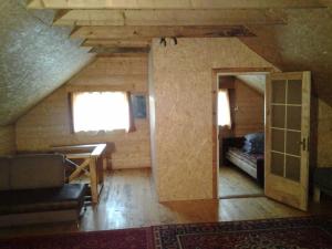 an attic room with a bed and a desk in a room at Huntingbox in Purila