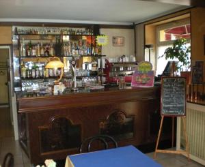 a bar in a restaurant with a sign at Aux Quatre Vents in Saulieu