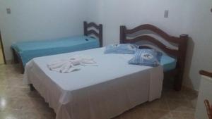 Giường trong phòng chung tại Pousada Lagoa Azul