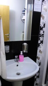 a bathroom with a white sink and a mirror at Elite Apartment Konaci in Kopaonik