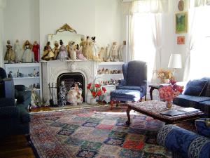 a living room with a fireplace filled with figurines at The Historic Mansion in New Haven