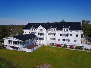 an aerial view of a large white house with a yard at Arendal Herregaard Spa & Resort in Arendal