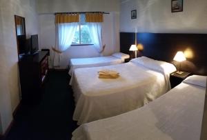 Säng eller sängar i ett rum på Hotel Solyma