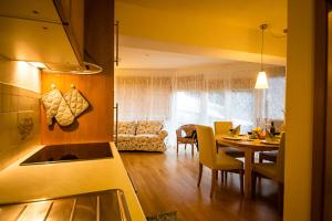 a kitchen and living room with a table and a dining room at Residenz Maroi in Sankt Anton am Arlberg