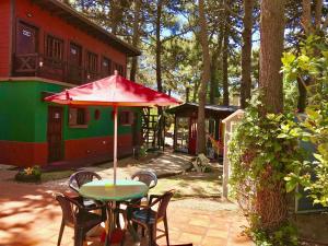 a patio with a table and chairs and an umbrella at B&B Mi Casa Es Tu Casa in Mar Azul