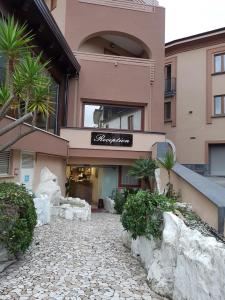 a building with a sign on the side of it at Hotel Santa Caterina in Fisciano +2 photos
