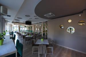 a dining room with tables and chairs at Aparthotel Park in Brčko