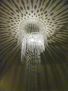 a glass chandelier hanging from a wall at Lyzzick Hall Hotel in Keswick