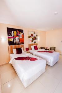 a hotel room with two beds in a room at Roseate Chiang Mai in Chiang Mai