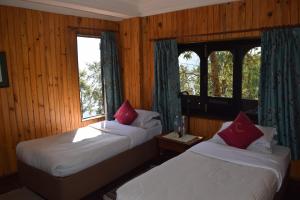 A bed or beds in a room at The Fort Resort