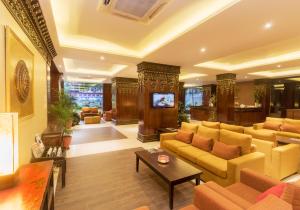 
a living room filled with furniture and a large window at Hotel Tibet International in Kathmandu
