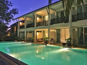 a large swimming pool in front of a house at Sarikantang Resort & Spa, Koh Phangan in Haad Rin