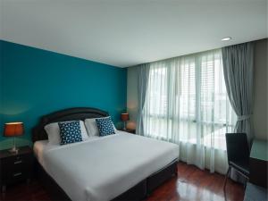 Postel nebo postele na pokoji v ubytování Silom Lofts