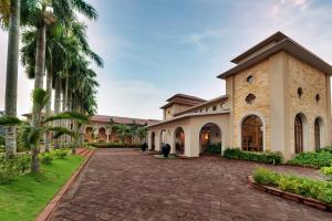 an exterior view of a building with a brick driveway at Ibiza The Fern Resort & Spa, Kolkata in Kolkata