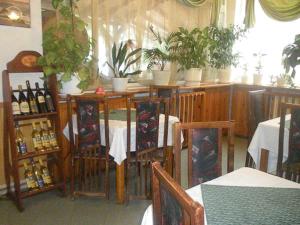 a restaurant with a table and chairs and plants at Hotel- Restaurant Struma in Stara Kresna