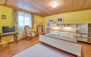 a bedroom with a bed and a desk and a television at Appartement Rainer in Saalbach Hinterglemm