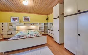 a bedroom with a white bed and a wooden ceiling at Appartement Rainer in Saalbach-Hinterglemm