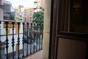 a view of a balcony with a fence and some buildings at ApartEasy - Montjuïc & Fira in Barcelona