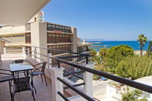 a balcony with a table and chairs and the ocean at Alkyonida Apartments in Chania