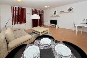 a living room with a couch and a table at iHome Apartment 3.0 in Pécs