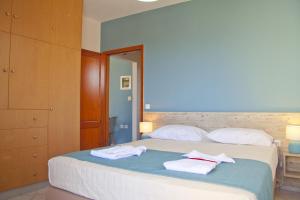 a bedroom with a bed with towels on it at Alkyonida Apartments in Chania