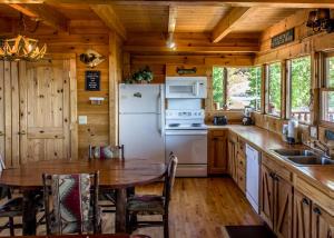a kitchen with a table and a white refrigerator at Fox Ridge #37 in Sevierville