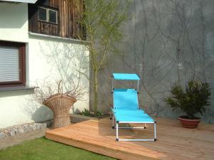 a blue chair sitting on a wooden deck at Ferienbungalow 1 in Dierkow