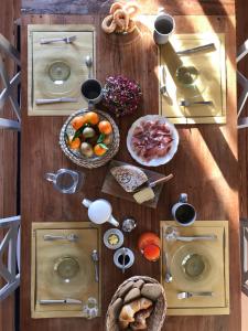 
a wooden table topped with plates of food at B&B Villa Tavallini in Pollone
