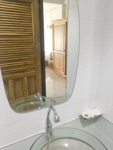 a bathroom with a sink and a mirror at Baan Bangrak Residence in Trang