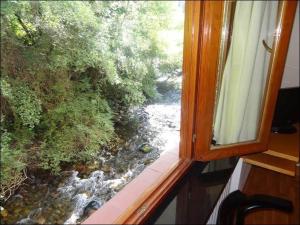 a view of a river from a window at Hotel Restaurante Marroncín in Cangas del Narcea