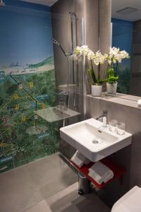 a bathroom with a sink and a shower at Hotel Elite in Crans-Montana